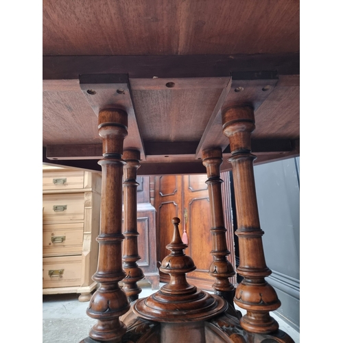 1023 - A Victorian walnut octagonal centre table, with well figured quarter veneered top, 99cm wide.... 