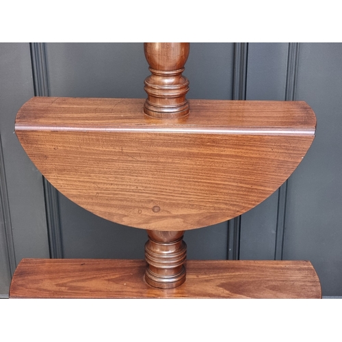 1028 - A George IV mahogany three-tier drop leaf dumb waiter, 123cm high.