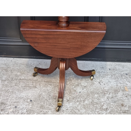 1028 - A George IV mahogany three-tier drop leaf dumb waiter, 123cm high.