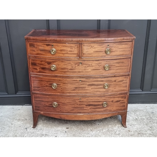 1038 - An early 19th century mahogany and satinwood crossbanded bowfront chest of drawers, 105.5cm wide.... 