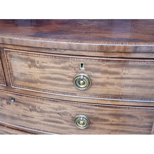 1038 - An early 19th century mahogany and satinwood crossbanded bowfront chest of drawers, 105.5cm wide.... 