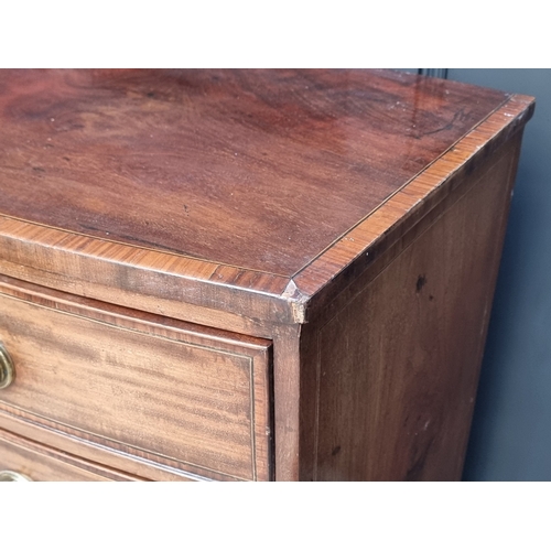 1038 - An early 19th century mahogany and satinwood crossbanded bowfront chest of drawers, 105.5cm wide.... 