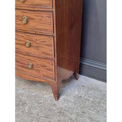 1038 - An early 19th century mahogany and satinwood crossbanded bowfront chest of drawers, 105.5cm wide.... 