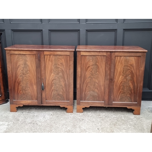 1049 - A pair of 19th century mahogany side cabinets, one enclosing drawers, the other shelves, 96cm wide.... 