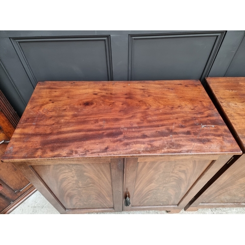 1049 - A pair of 19th century mahogany side cabinets, one enclosing drawers, the other shelves, 96cm wide.... 