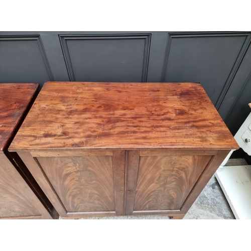 1049 - A pair of 19th century mahogany side cabinets, one enclosing drawers, the other shelves, 96cm wide.... 