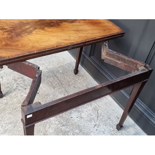 1051 - A George III figured mahogany and crossbanded serpentine concertina card table, 91.5cm wide.... 