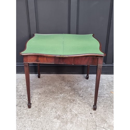 1051 - A George III figured mahogany and crossbanded serpentine concertina card table, 91.5cm wide.... 