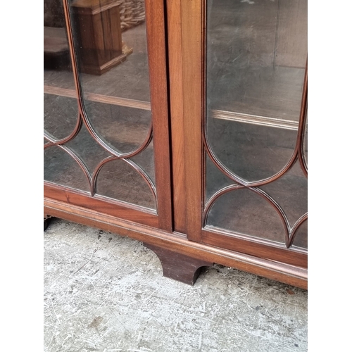 1053 - A large early 20th century mahogany bookcase, 190cm wide.