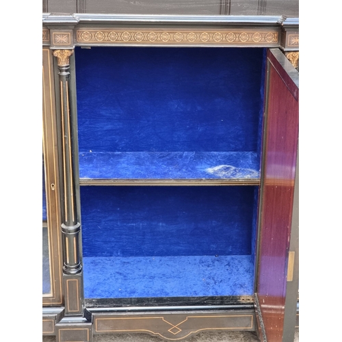 1054 - A mid-Victorian ebonized credenza, incorporating bone inlay, 172cm wide.