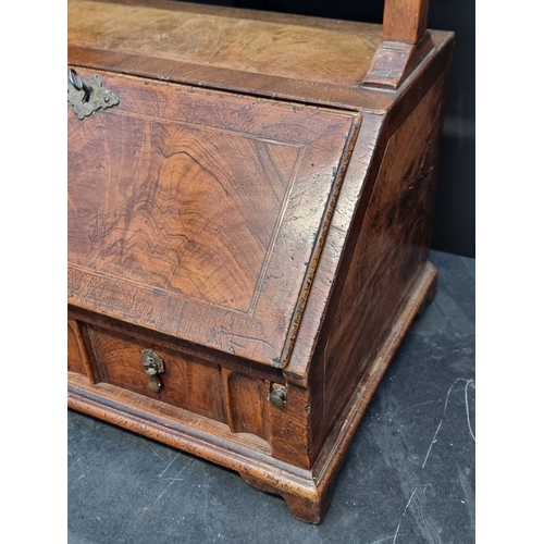 1055 - A George I walnut and feather banded mirror mounted table bureau, with fitted apron drawer, 93cm hig... 