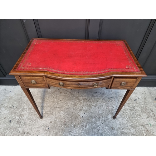 1057 - An Edwardian mahogany and line inlaid bowfront desk, 91.5cm wide.