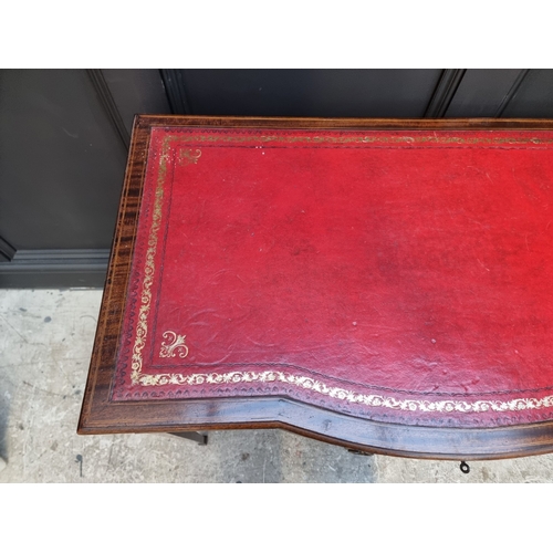 1057 - An Edwardian mahogany and line inlaid bowfront desk, 91.5cm wide.