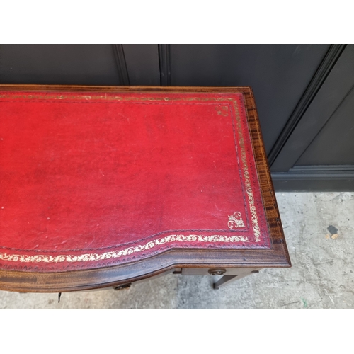 1057 - An Edwardian mahogany and line inlaid bowfront desk, 91.5cm wide.