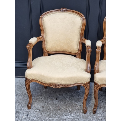 1061 - A pair of Louis XV style carved walnut fauteuils.