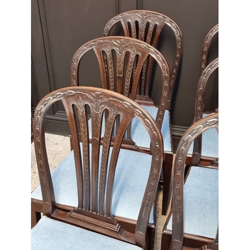 1062 - A set of six George III carved mahogany dining chairs.