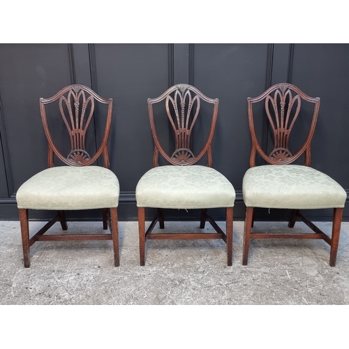 1063 - A set of three George III mahogany dining chairs.