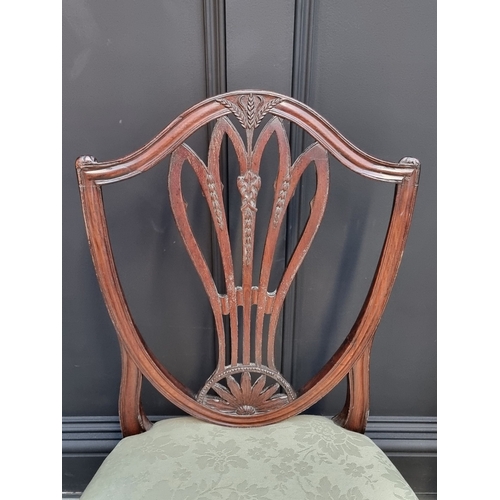 1063 - A set of three George III mahogany dining chairs.