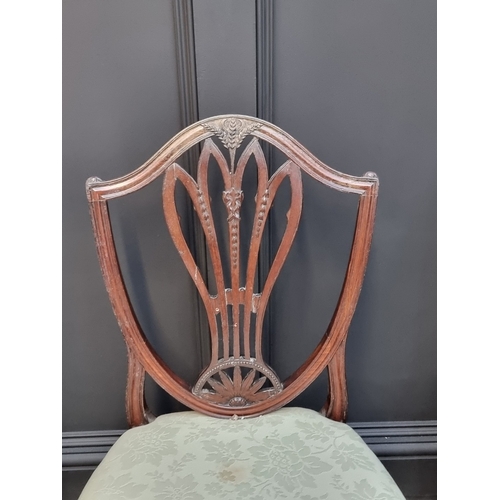 1063 - A set of three George III mahogany dining chairs.