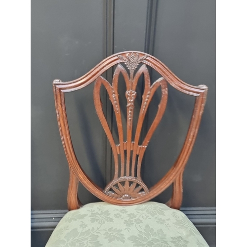 1063 - A set of three George III mahogany dining chairs.