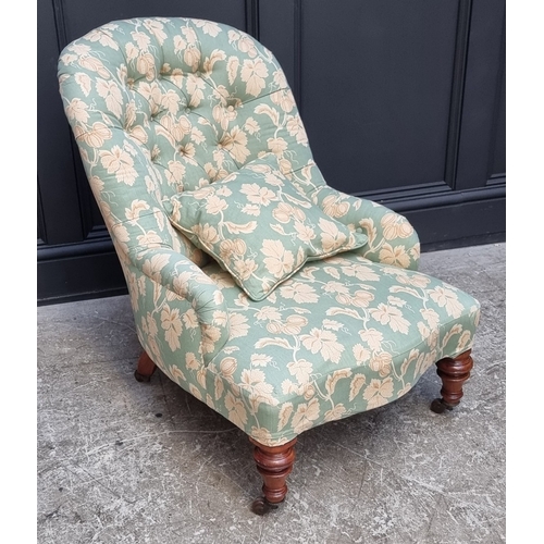 1065 - A Victorian walnut and button upholstered nursing chair.