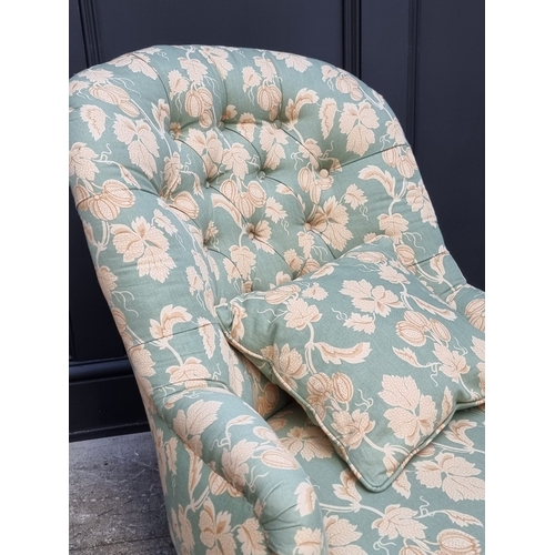 1065 - A Victorian walnut and button upholstered nursing chair.