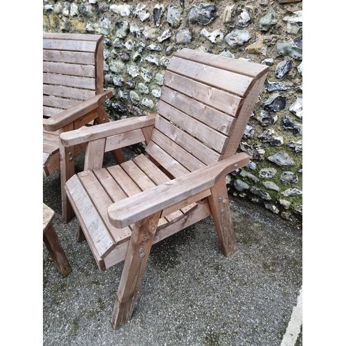 1453 - A pair of pine garden armchairs and matching oval table, 79cm wide.