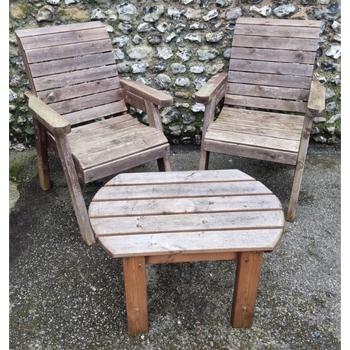 1454 - A pair of pine garden armchairs and matching oval table, 79cm wide.