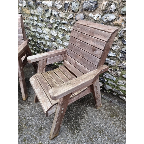 1454 - A pair of pine garden armchairs and matching oval table, 79cm wide.