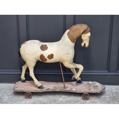 1455 - An antique French push-along horse, with pony hide skin, 114.5cm long.