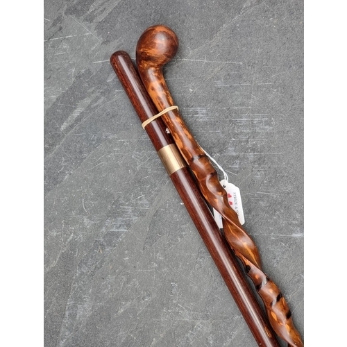 1446 - A 9ct gold mounted hardwood cane; together with another unusual spiral twisted wood cane. (2)... 