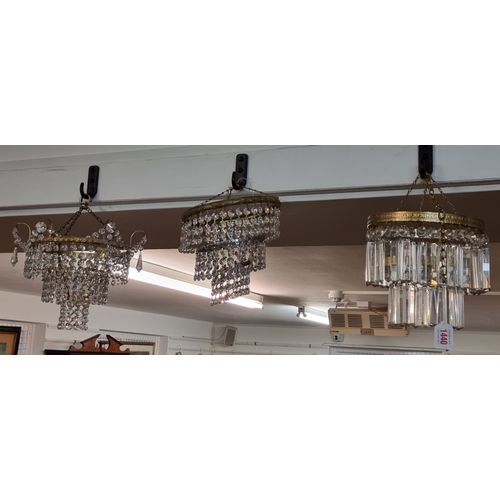 1440 - A faceted glass drop two-tier chandelier, 19cm high; together with two other faceted drop ceiling li... 