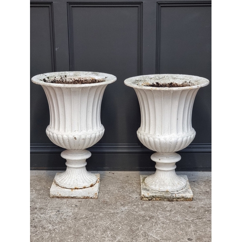 1449 - A large pair of Victorian white painted cast iron Campana urns, 74.5cm high.En suite with the next l... 