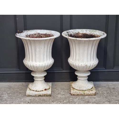 1450 - A large pair of Victorian white painted cast iron Campana urns, 74.5cm high.En suite with the previo... 