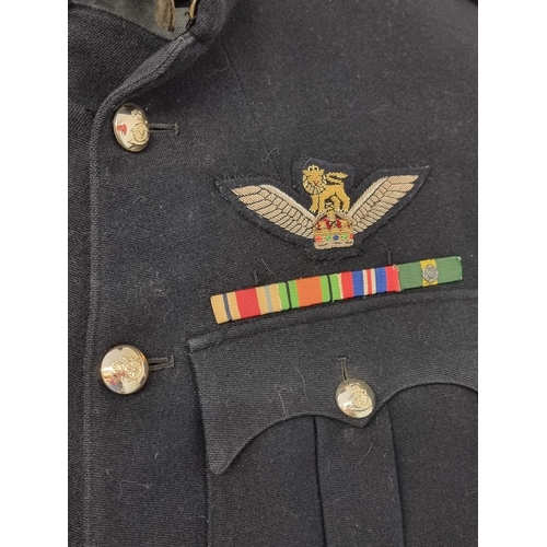 21 - A 1950s British army majors dress blues tunic, with pilots and parachute wings; together with a comm... 