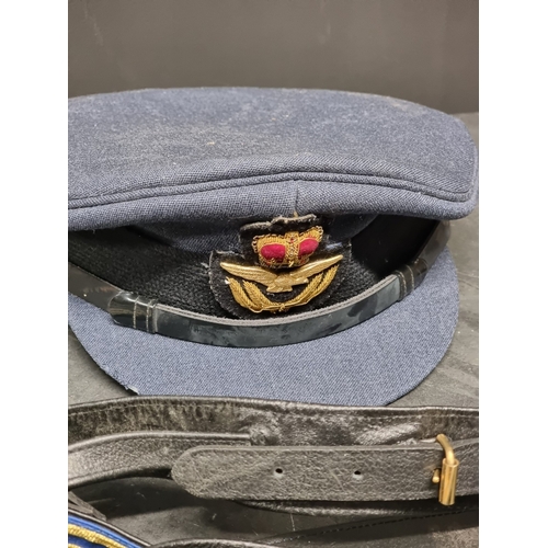 28 - A collection of RAF items, comprising: insignia, patches, wings, an officers peaked cap, and a sword... 