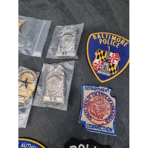 30 - A large quantity of US Police and other metal and fabric badges.