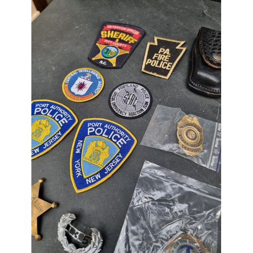 30 - A large quantity of US Police and other metal and fabric badges.