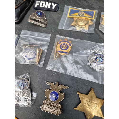 30 - A large quantity of US Police and other metal and fabric badges.