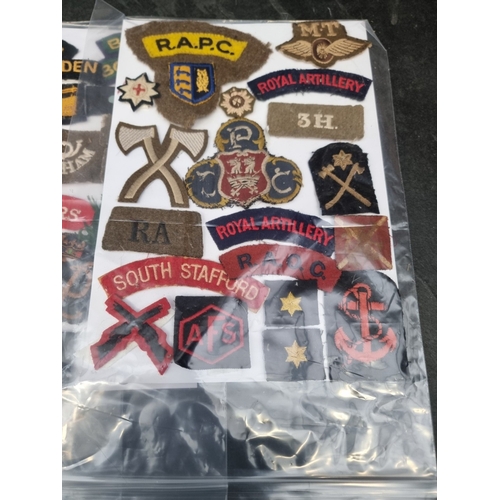 35 - A large selection of assorted WWII cloth patches; together with a quantity of formation signs; photo... 