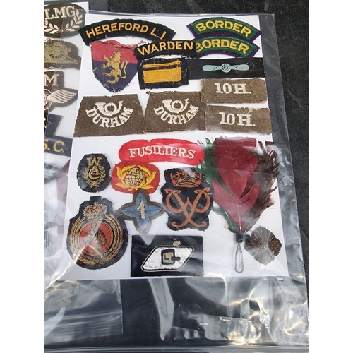 35 - A large selection of assorted WWII cloth patches; together with a quantity of formation signs; photo... 