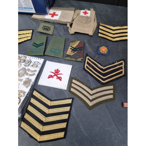 36 - A large selection of post WWII British military cap, collar and shoulder titles; together with a qua... 