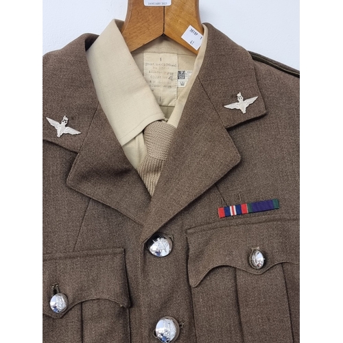 41 - A circa 1963 officers service dress tunic, shirt and tie, with silver plated officer collar badges, ... 