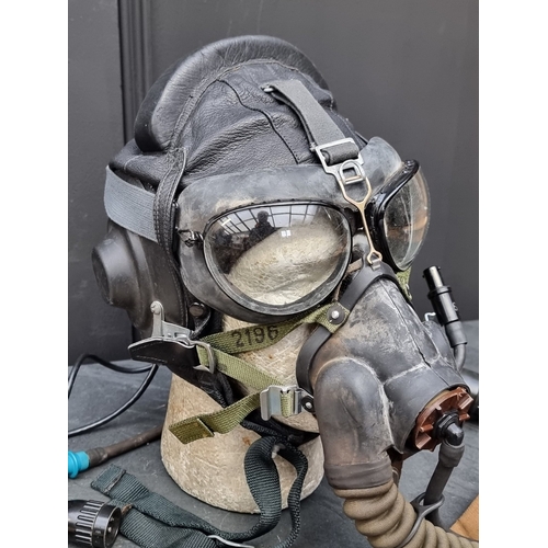 50 - A 1982 Soviet Mig pilot's leather flying helmet, size 58cm; together with goggles; and an oxygen mas... 