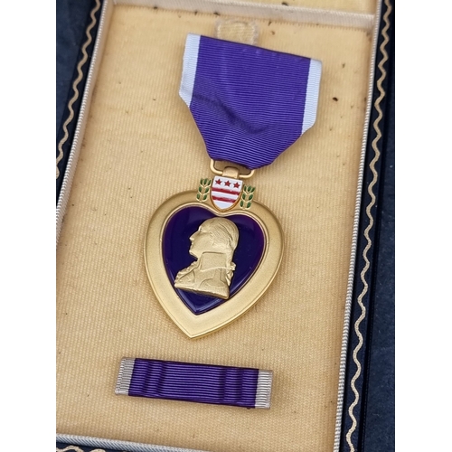 53 - Medals: a WWII US military Silver Star, with ‘V‘ for valour emblem; and a Purple Heart, with tunic m... 