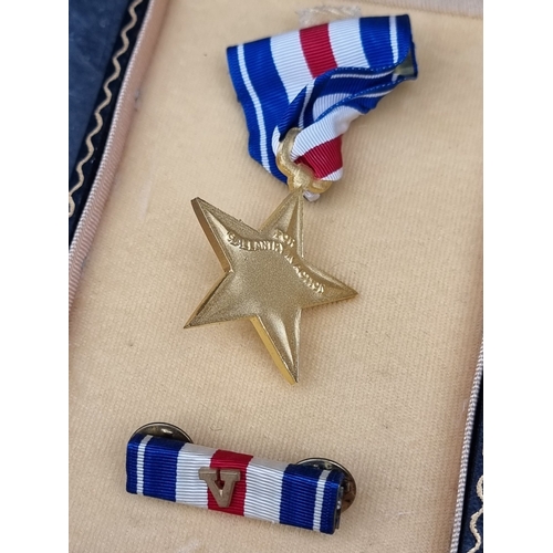 53 - Medals: a WWII US military Silver Star, with ‘V‘ for valour emblem; and a Purple Heart, with tunic m... 