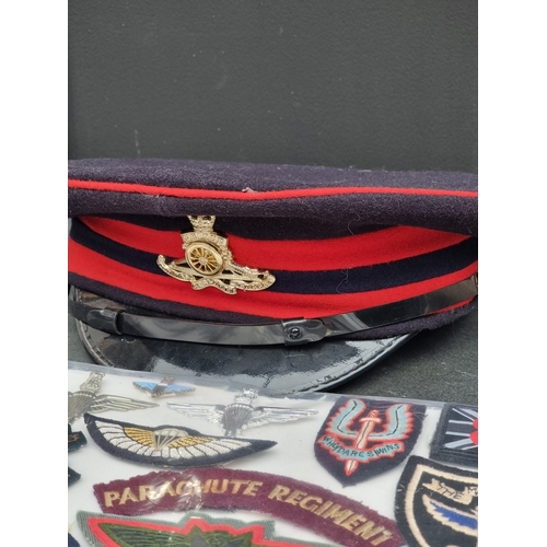 54 - A Royal Artillery Officer's visor cap; together with three various berets; and a quantity of Special... 