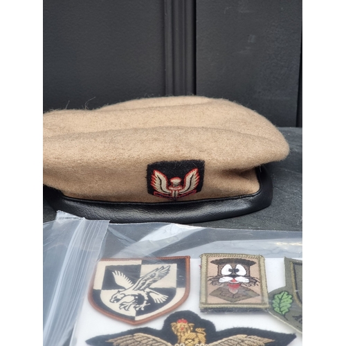 54 - A Royal Artillery Officer's visor cap; together with three various berets; and a quantity of Special... 