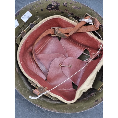 61 - A Korean War Thai infantry steel helmet, with lining, chinstrap and badge, purposed from a WWII Japa... 