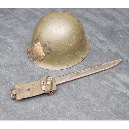 61 - A Korean War Thai infantry steel helmet, with lining, chinstrap and badge, purposed from a WWII Japa... 